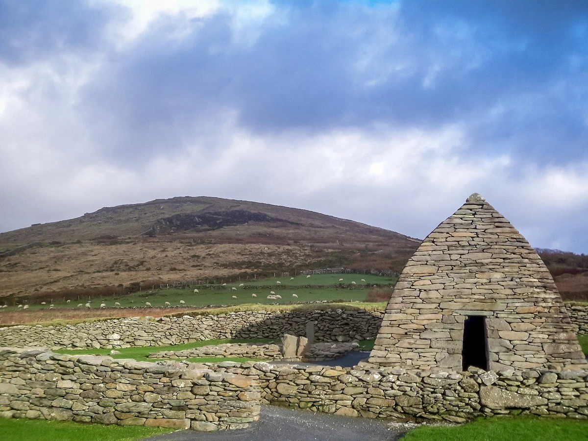 Stone hut next to a stone wall