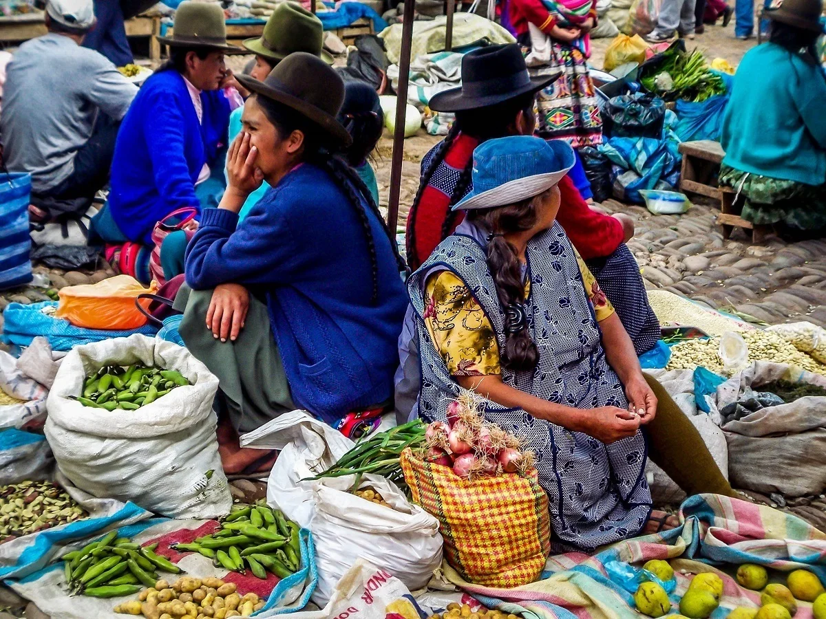 Vendors selling vegetables at the Pisac market