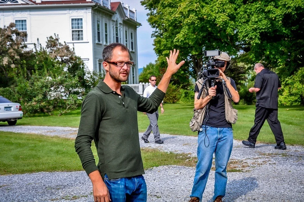 Man being filmed by a person with a TV camera