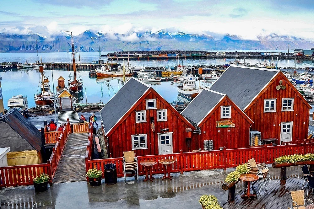 Wooden buildings beside boats in a harbor