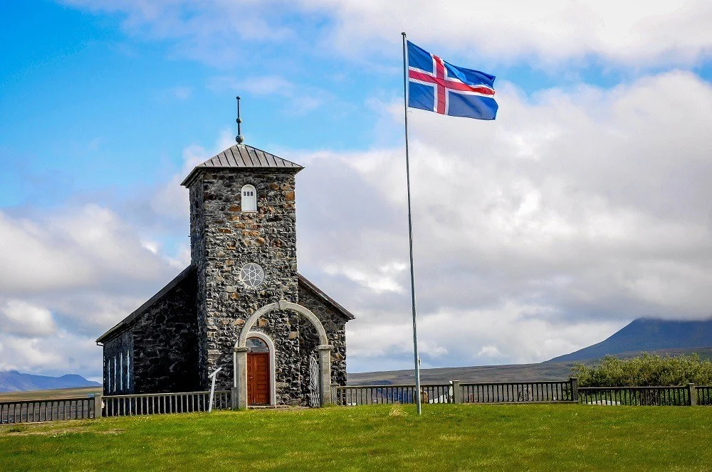 Beautiful stone church and flag on a trip to Iceland in September