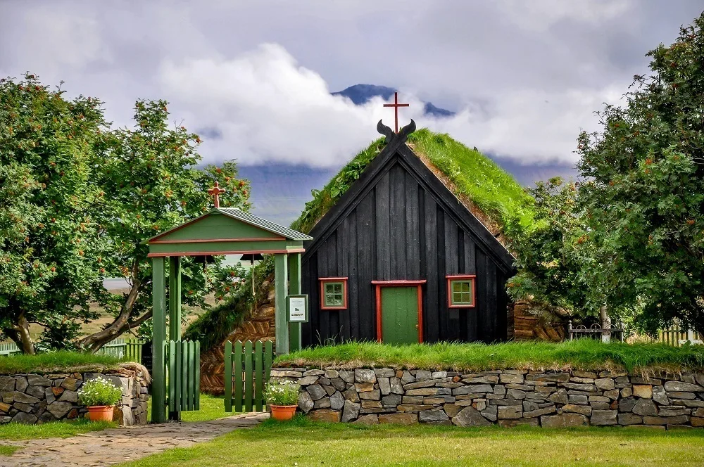 A beautiful turf church with a stone rock wall