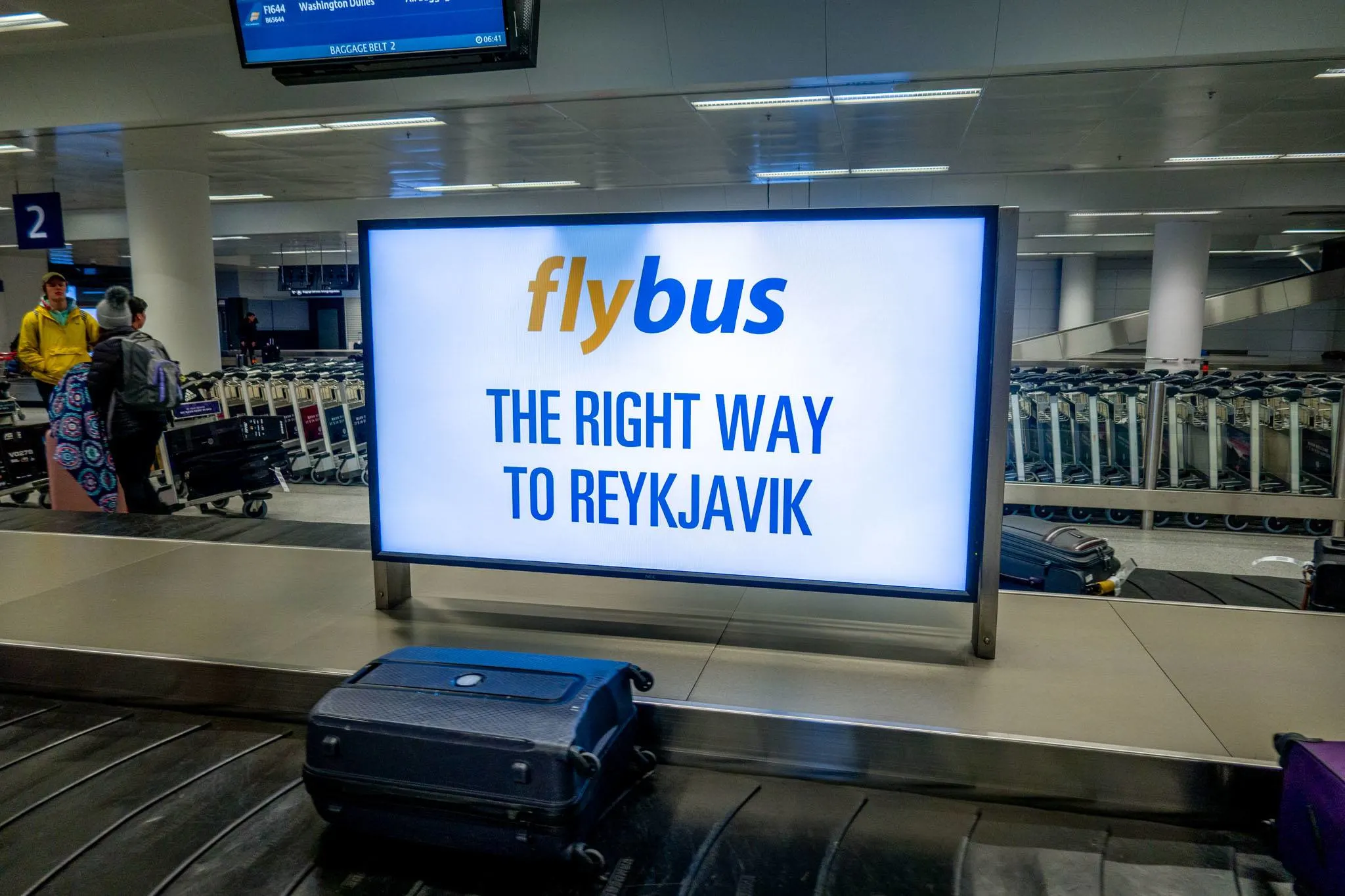 Reykjavik Excursions sign for the Flybus in the baggage claim area at Keflavik airport