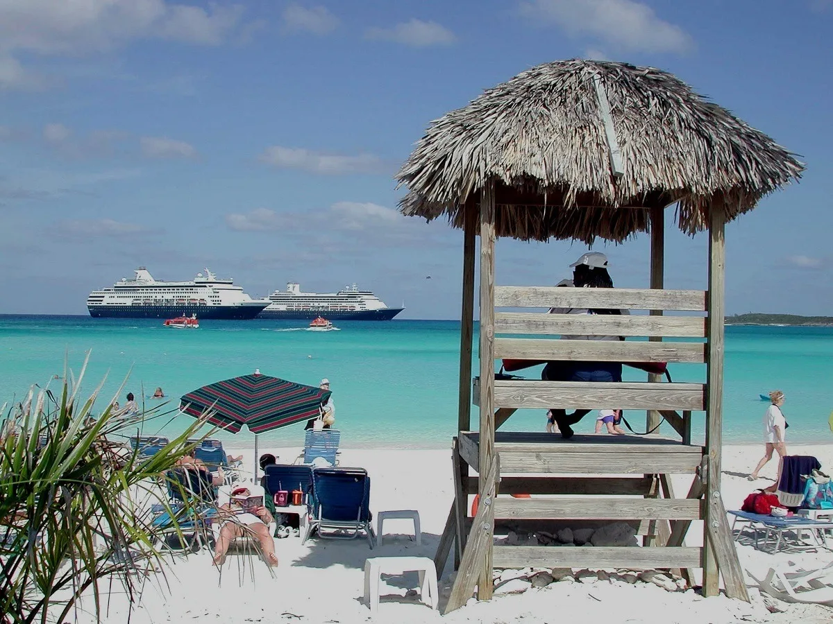 Two cruise ships off the shore of the company's private island