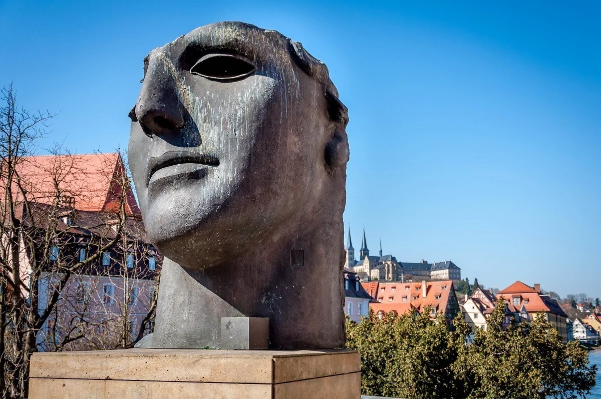 Statue of a face by the Alte Rathaus bridge