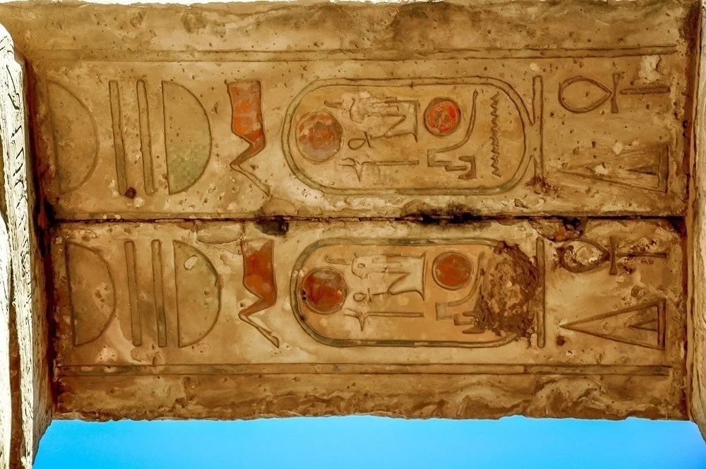 Colored cartouches on the underside of an arch at Karnak Temple