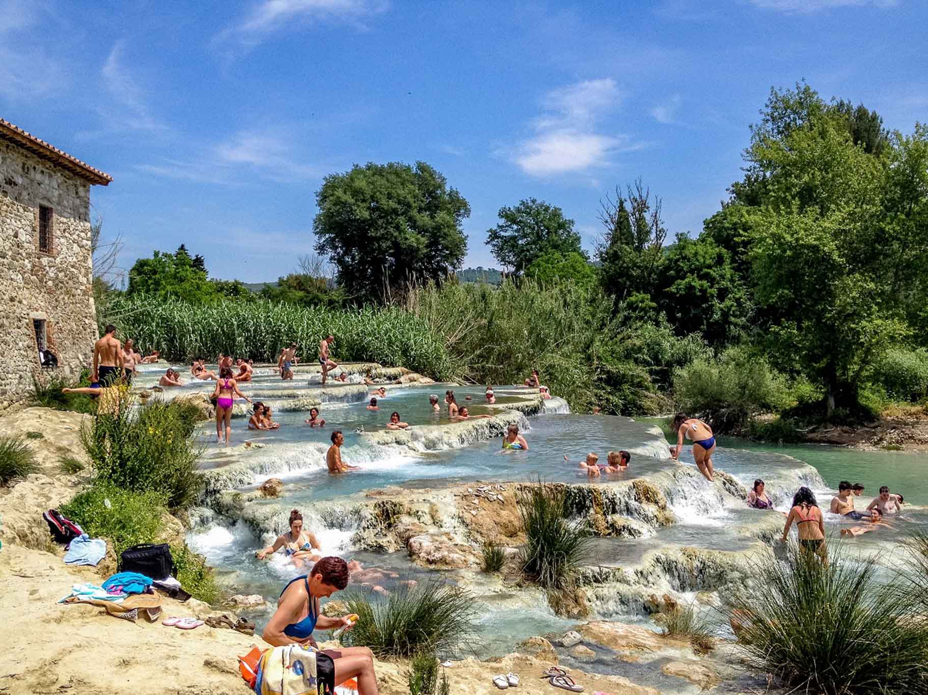People swimming in natural pools
