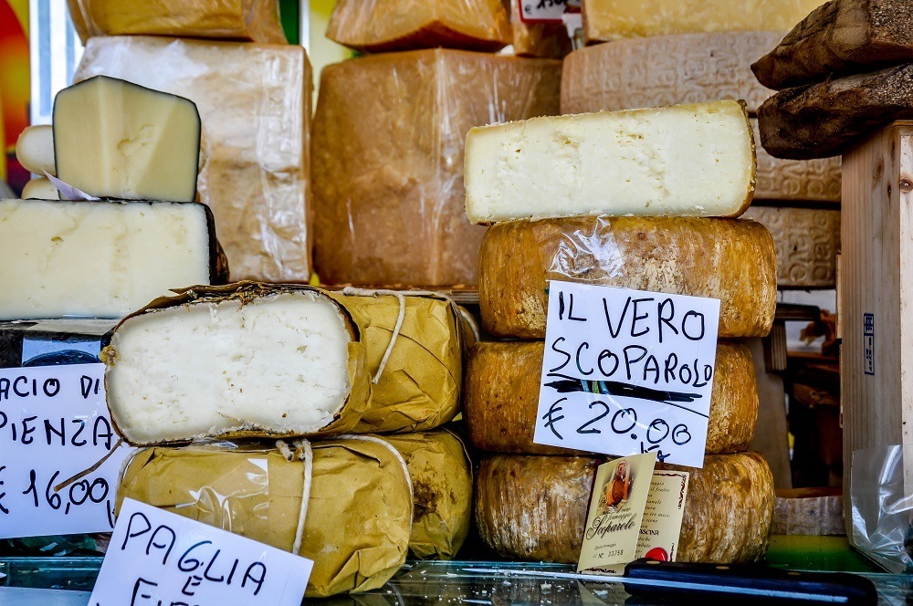 Wheels of cheeses at the Siena market