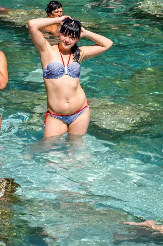 Female tourist posing in the Pamukkale Turkey hot springs pool