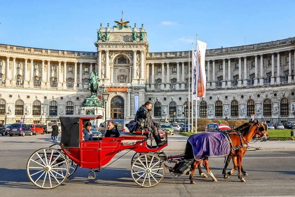 Horse-drawn coach outside the Hofburg Palace in Vienna, Austria