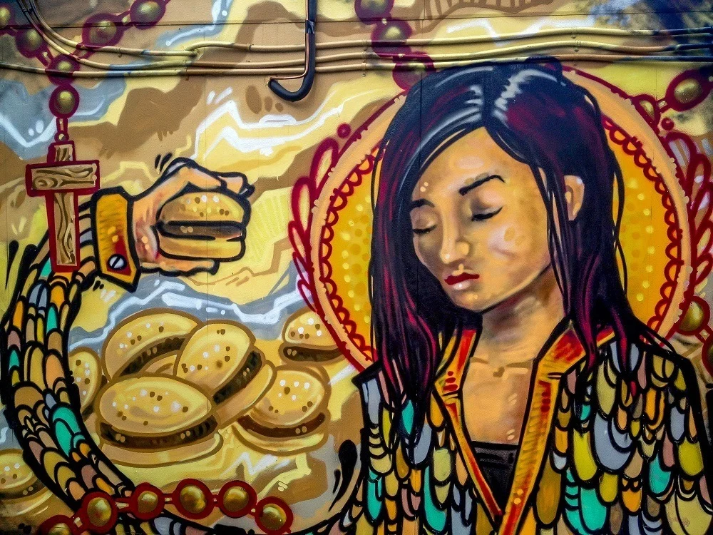 Mural of girl with hamburgers in Graffiti Alley Toronto