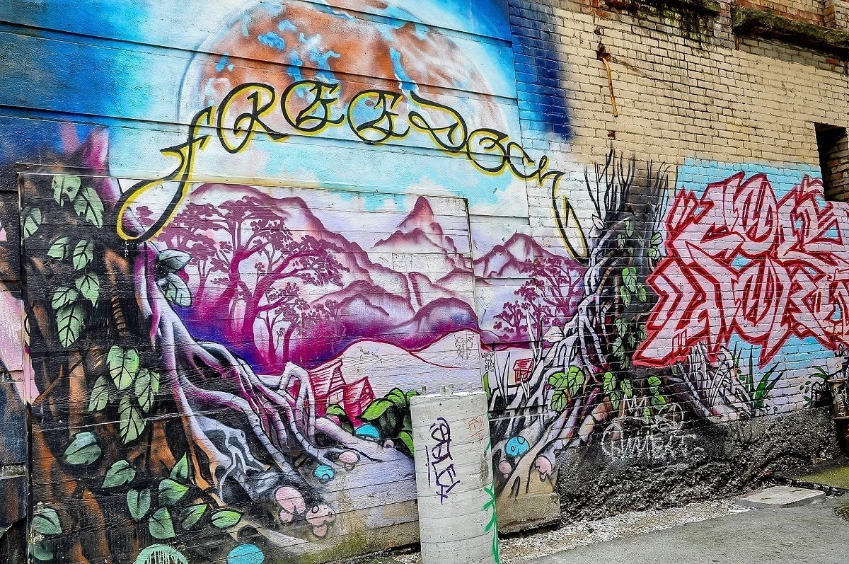 Mural of purple mountains with word  Freedom