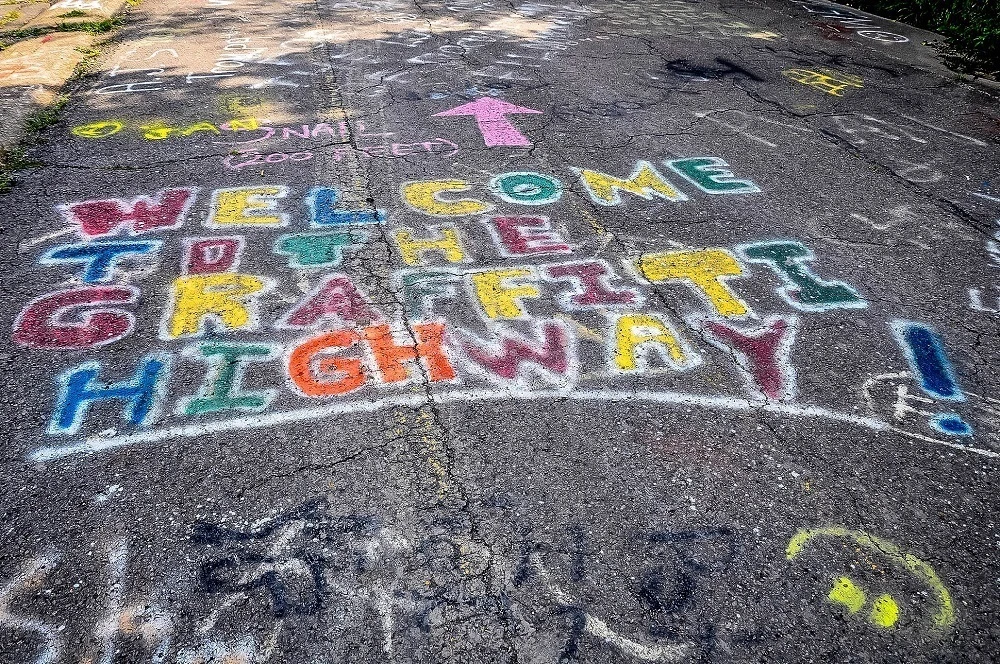 Spray painted graffiti saying Welcome to the Graffiti Highway