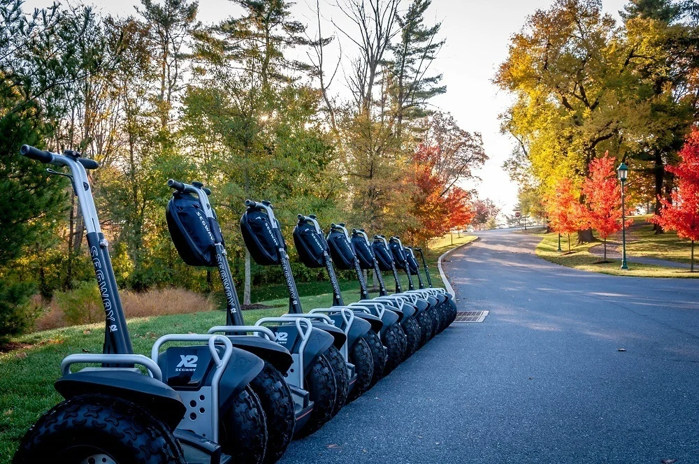 A group of Segways lined up on the grounds of the Hershey Hotel