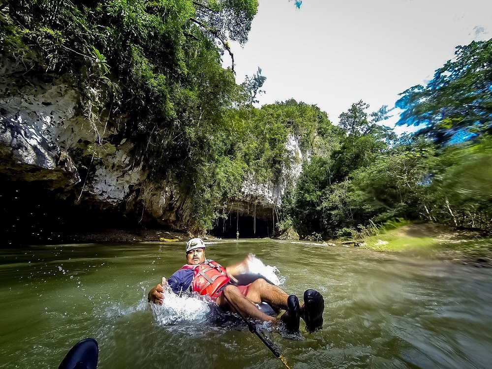 Our guide leading us cave tubing in Belize on the Caves Branch River