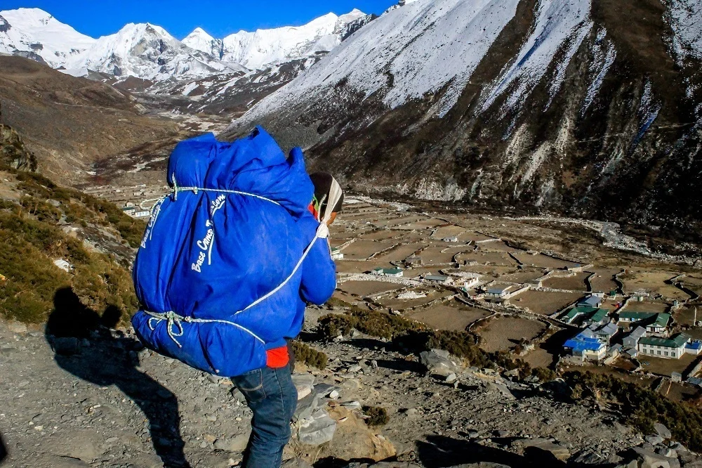 A Sherpa porter in Nepal carrying gear