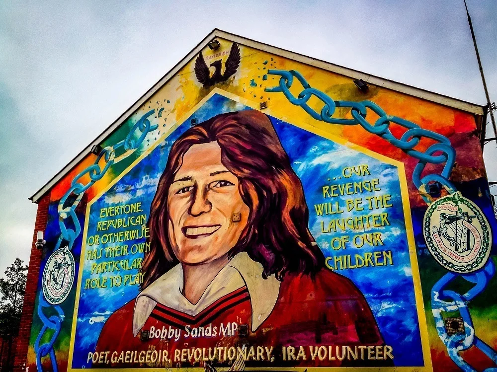 Colorful mural honoring Bobby Sands shows man and broken chains