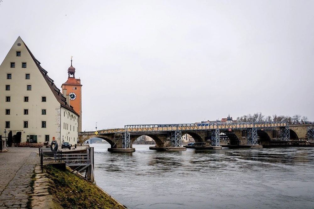 The Danube River is crossed by the Steinerne Brucke (Old Stone Bridge) in Regensburg