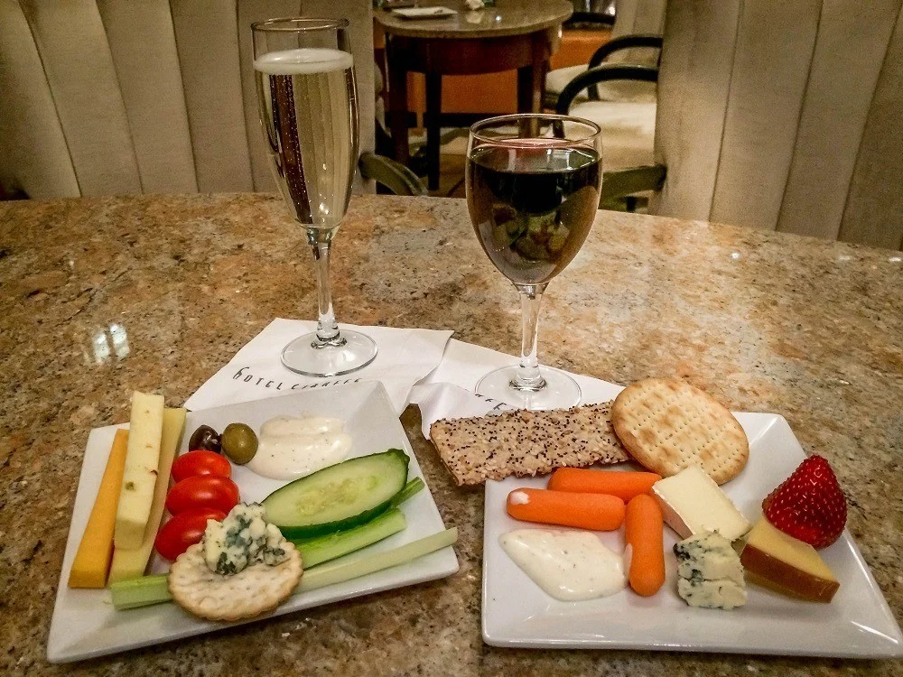 Glasses of wine and plates of cheese and vegetables at The Happy Hour