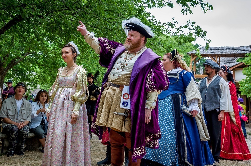 People dressed as royals in Renaissance capes and dresses