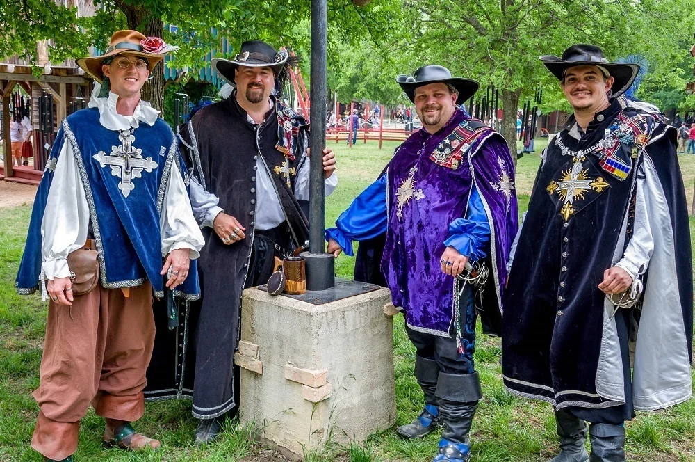 Men with capes and hats in Renaissance costume