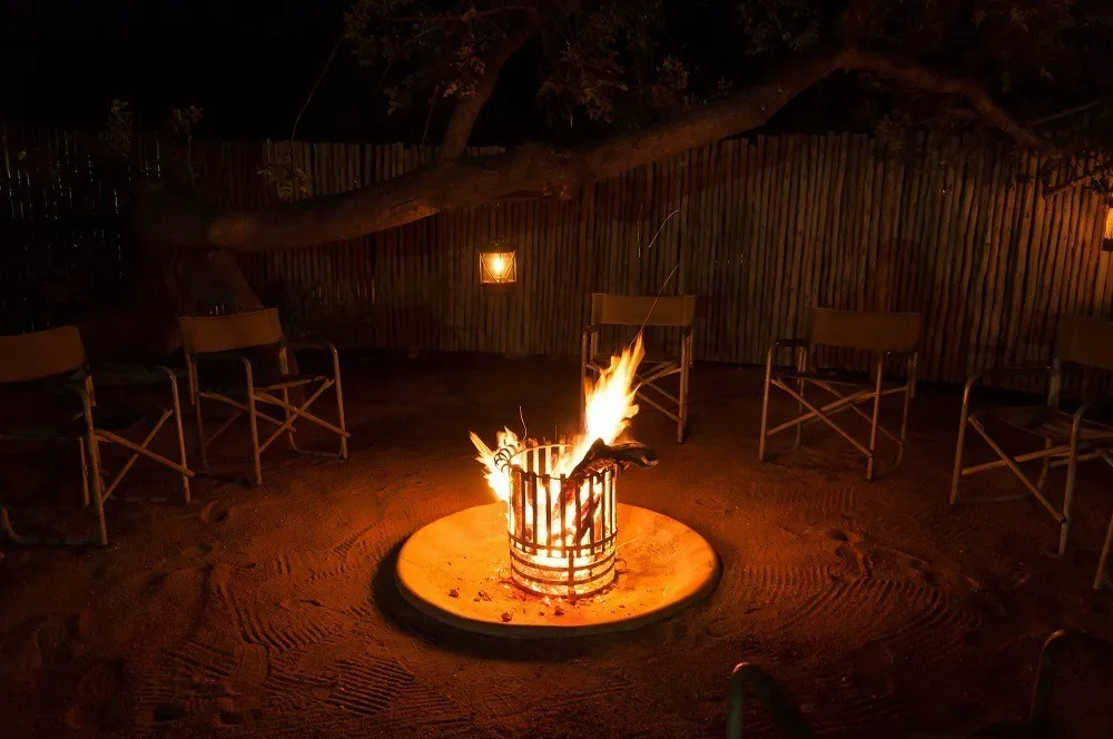 Fire pit with chairs at night