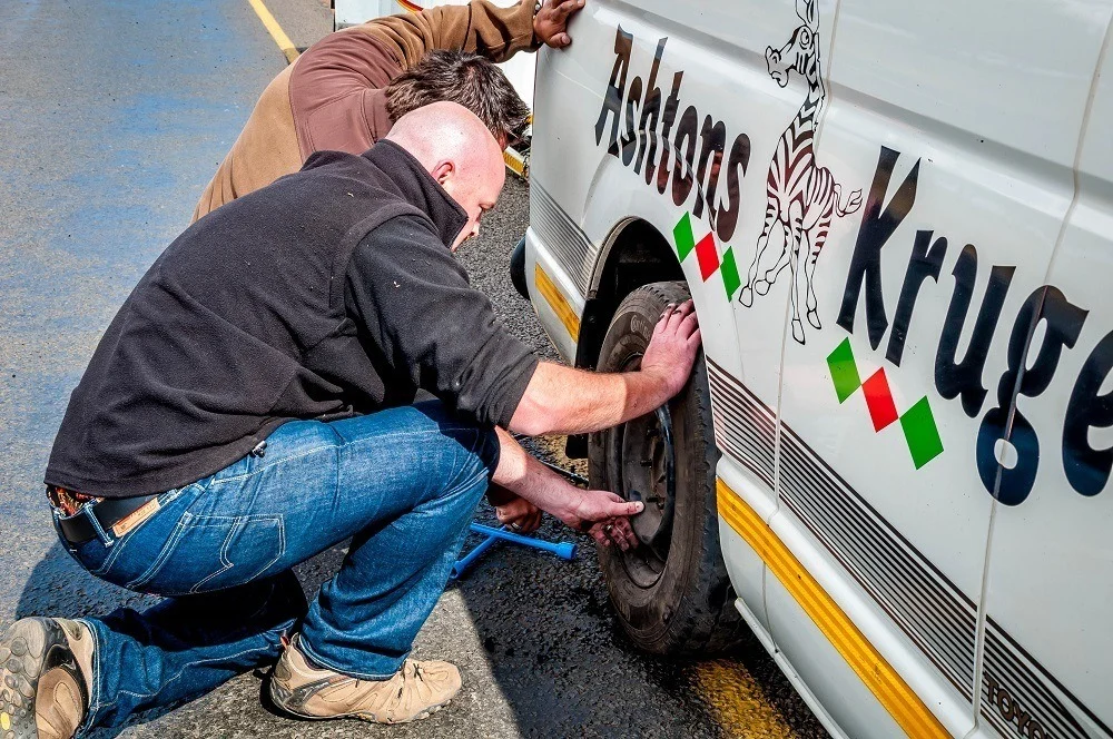 Men fixing a flat tire