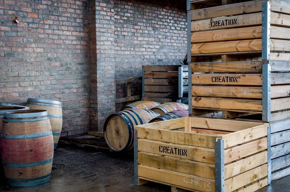 Wooden grape crates and wine barrels at Creation Wines