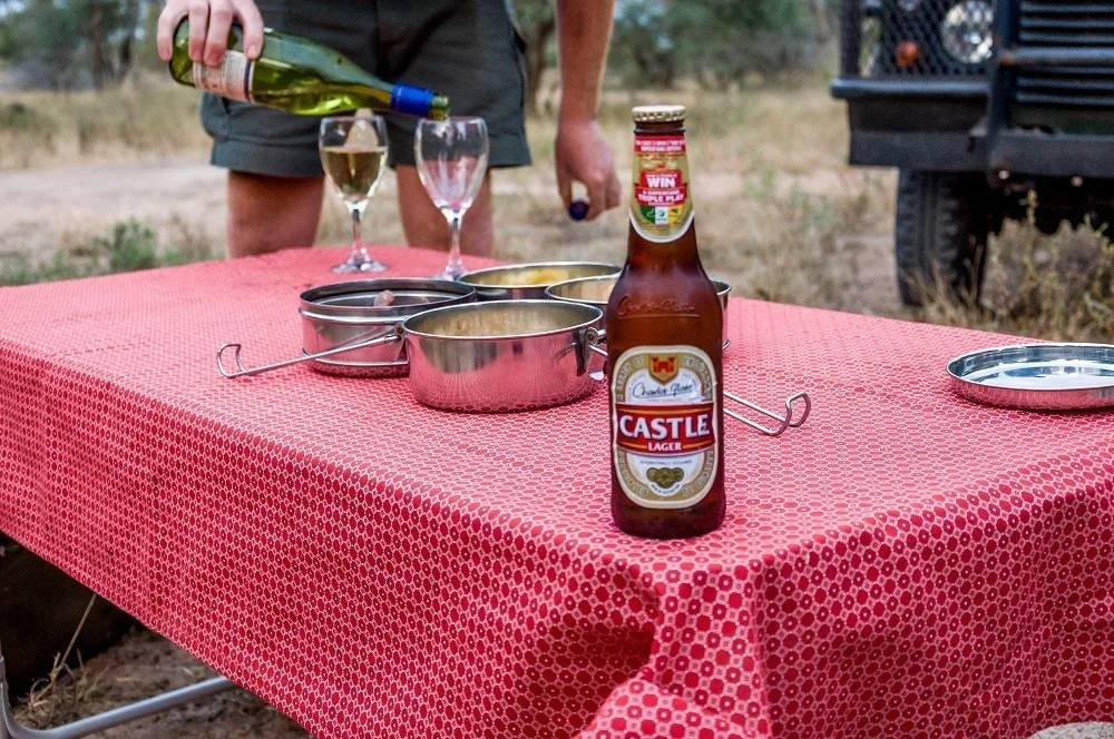 Safari sundowner with red tablecloth, beer and wine