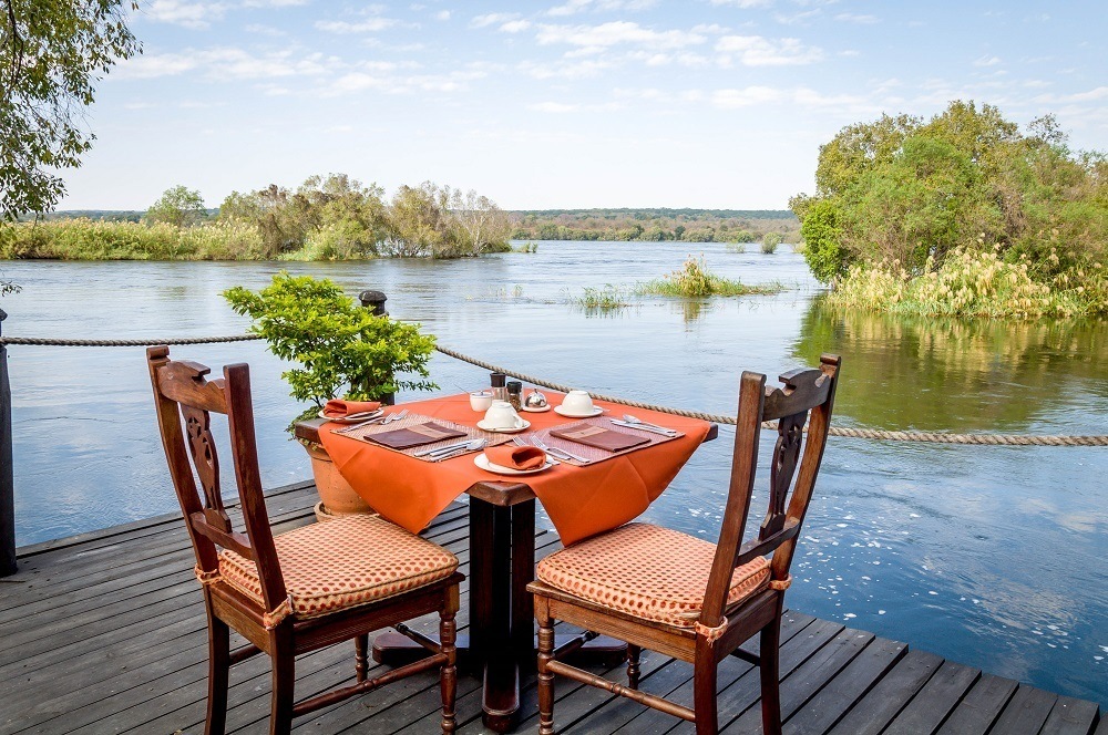 Al fresco dining at the river's edge at the Islands of Siankaba