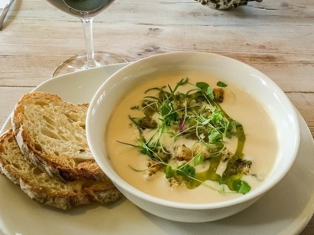 Cauliflower and Gorgonzola soup in bowl with bread