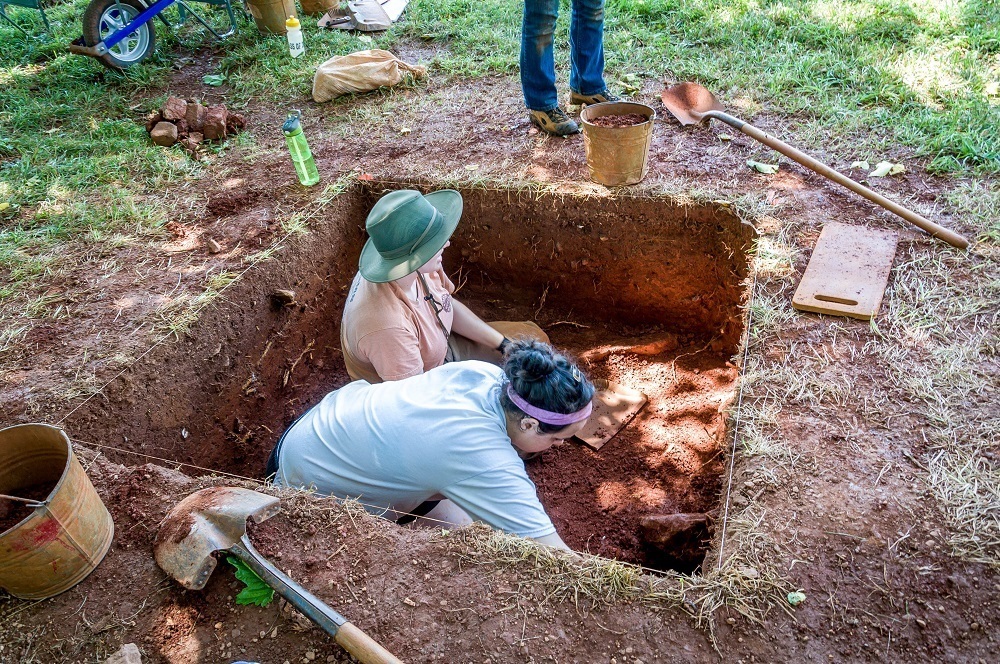 Two women conducting archaeological excavations on Mulberry Row
