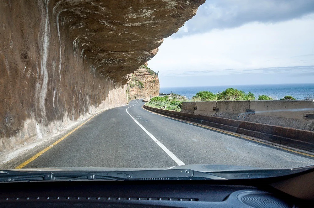 The road on Chapman's Peak Drive is carved into the side of a cliff