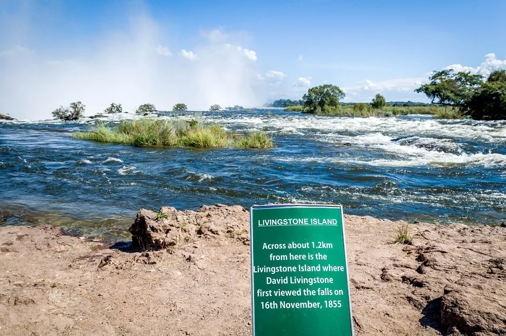 Sign reading: Livingstone Island; Across about 1.2 km from here is the Livingstone Island where David Livingstone first viewed the falls on 16th November 1855