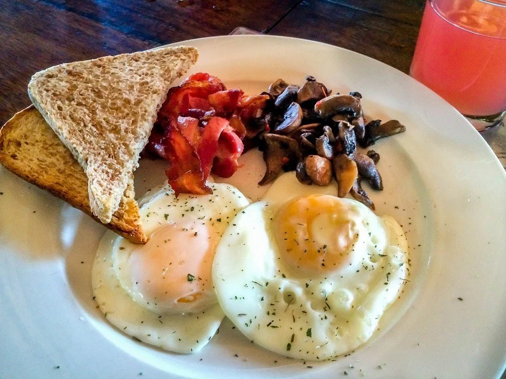The typical breakfast plate of eggs, toast, and mushrooms at nThambo Tree Camp