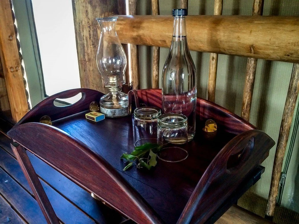 Table in the chalet with oil lamps and water glasses