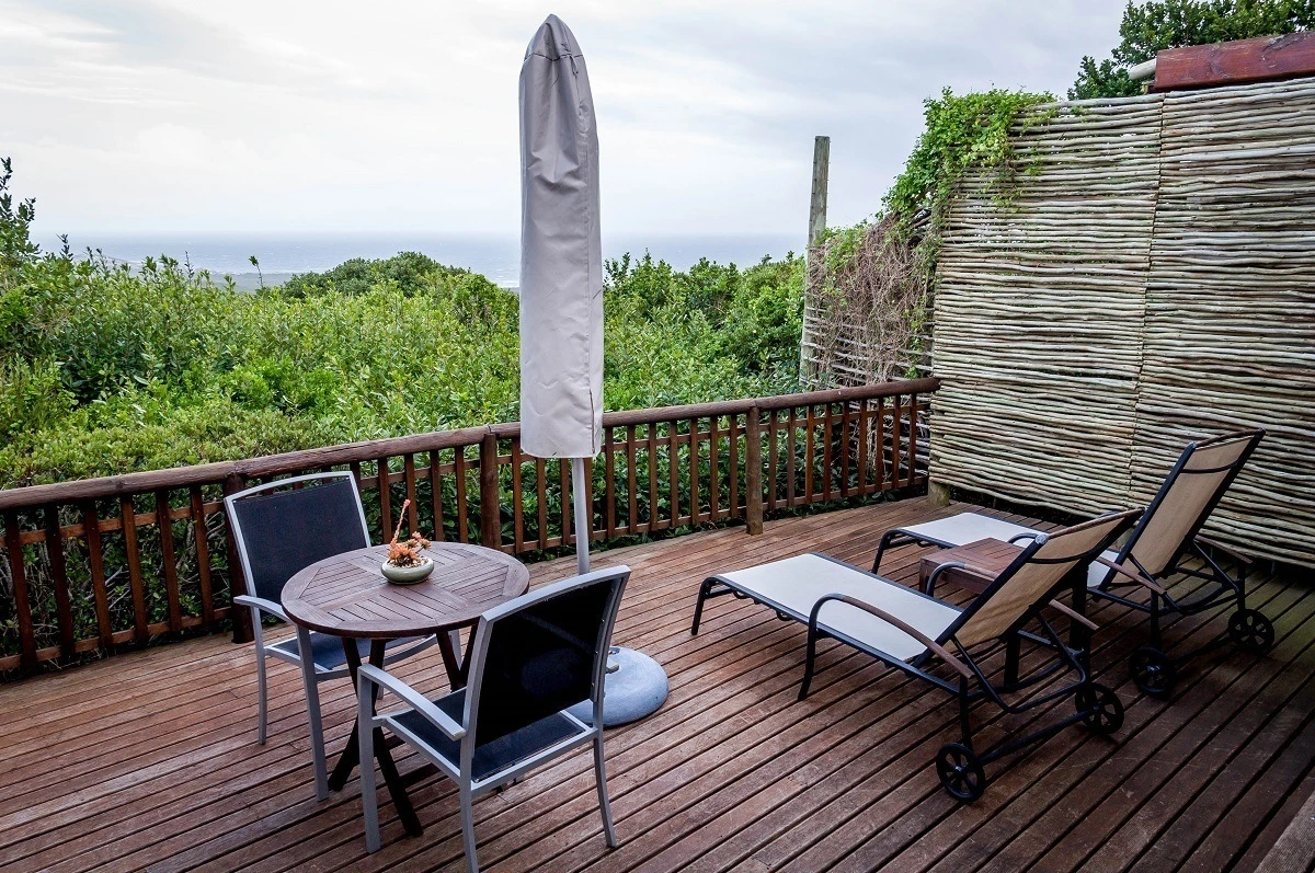 Table and recliners on the deck in a luxury suite at the Grootbos Private Nature Reserve
