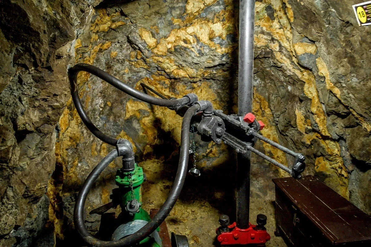 Miners use massive drills with water pumps deep inside the mine