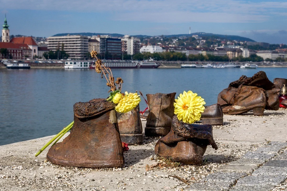 Yellow flowers in The Shoes on the Danube sculpture in Budapest