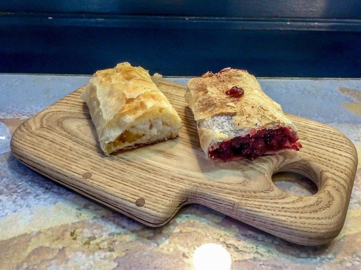 Cherry strudel and cheese strudel on a wooden board