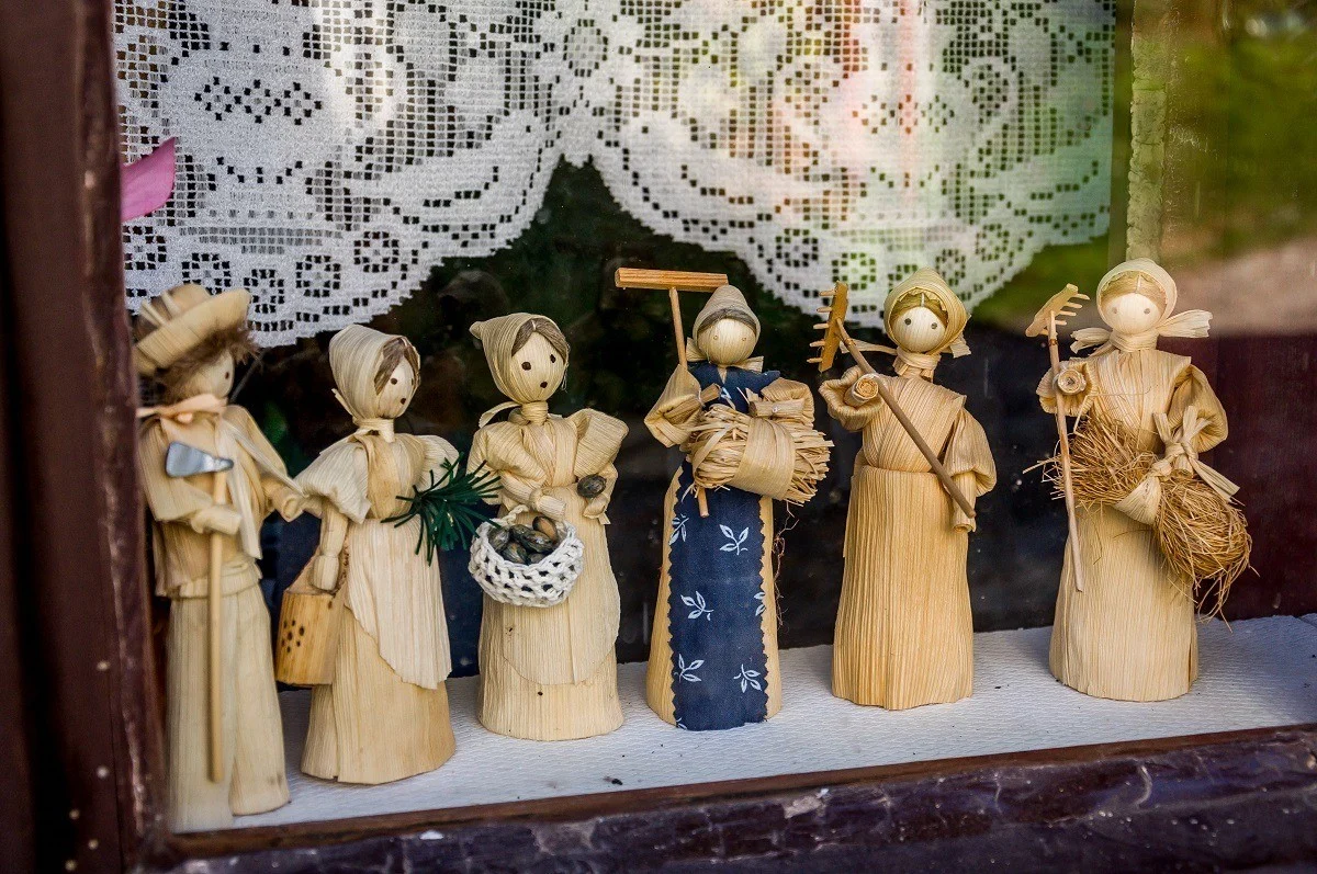 Corn husk dolls in a window