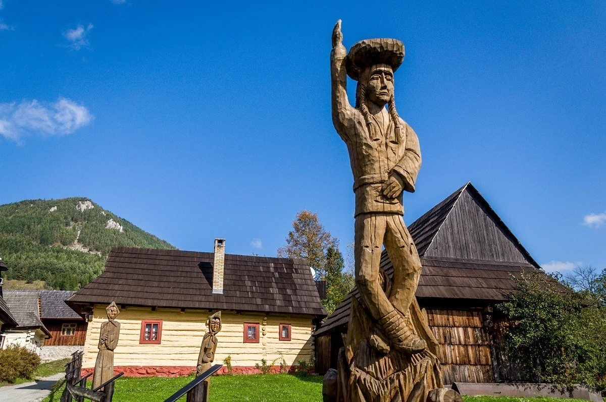 A carved wooden statue welcomes visitors to the rural village of Vlkolinec, Slovakia