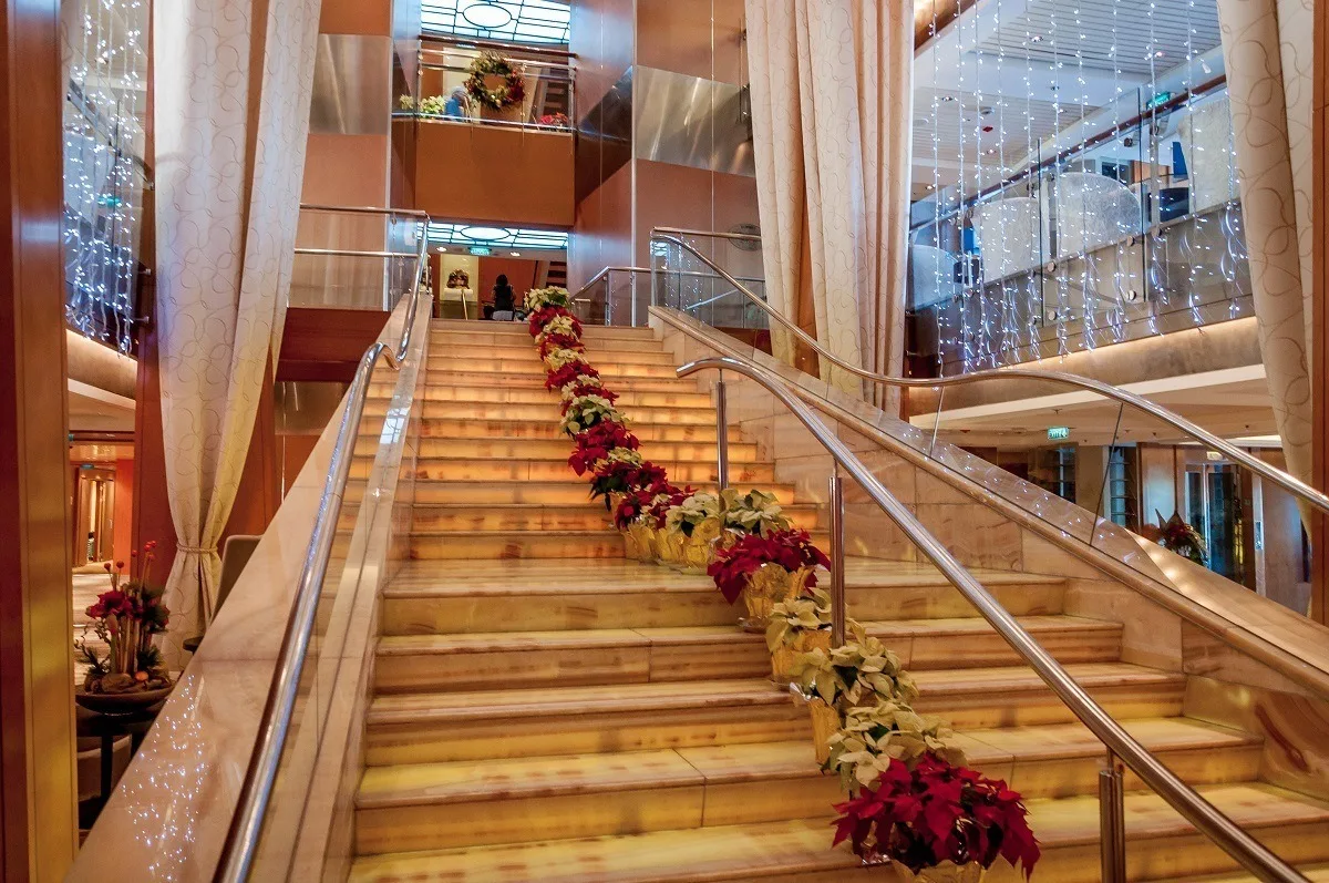 The main staircase of the ship lined with poinsettias 
