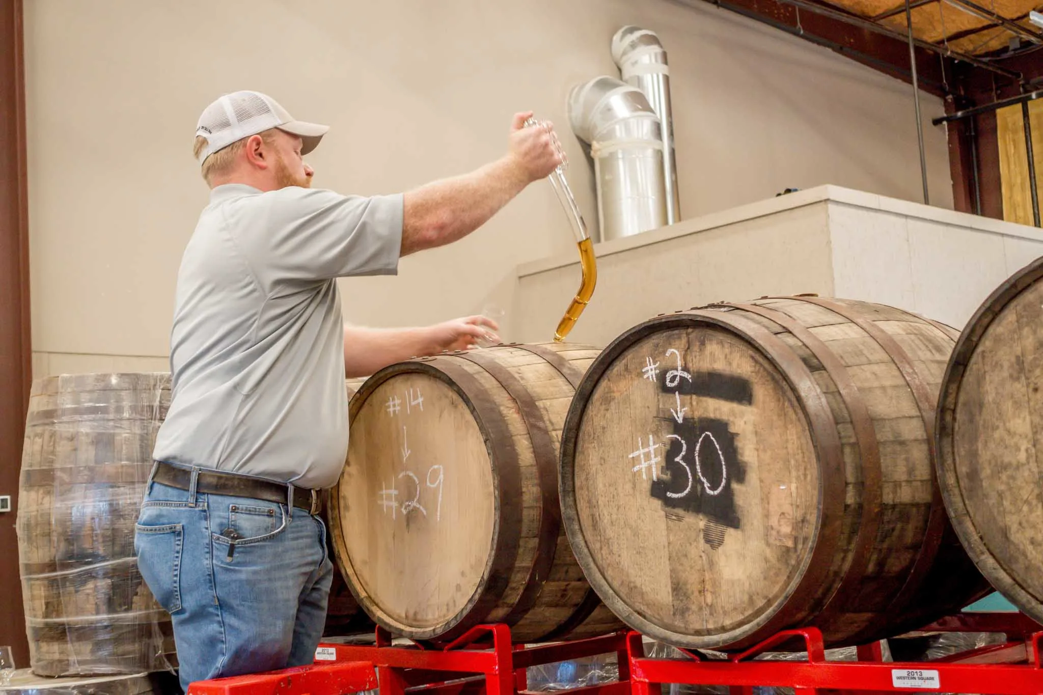 Man opening barrel of whiskey 