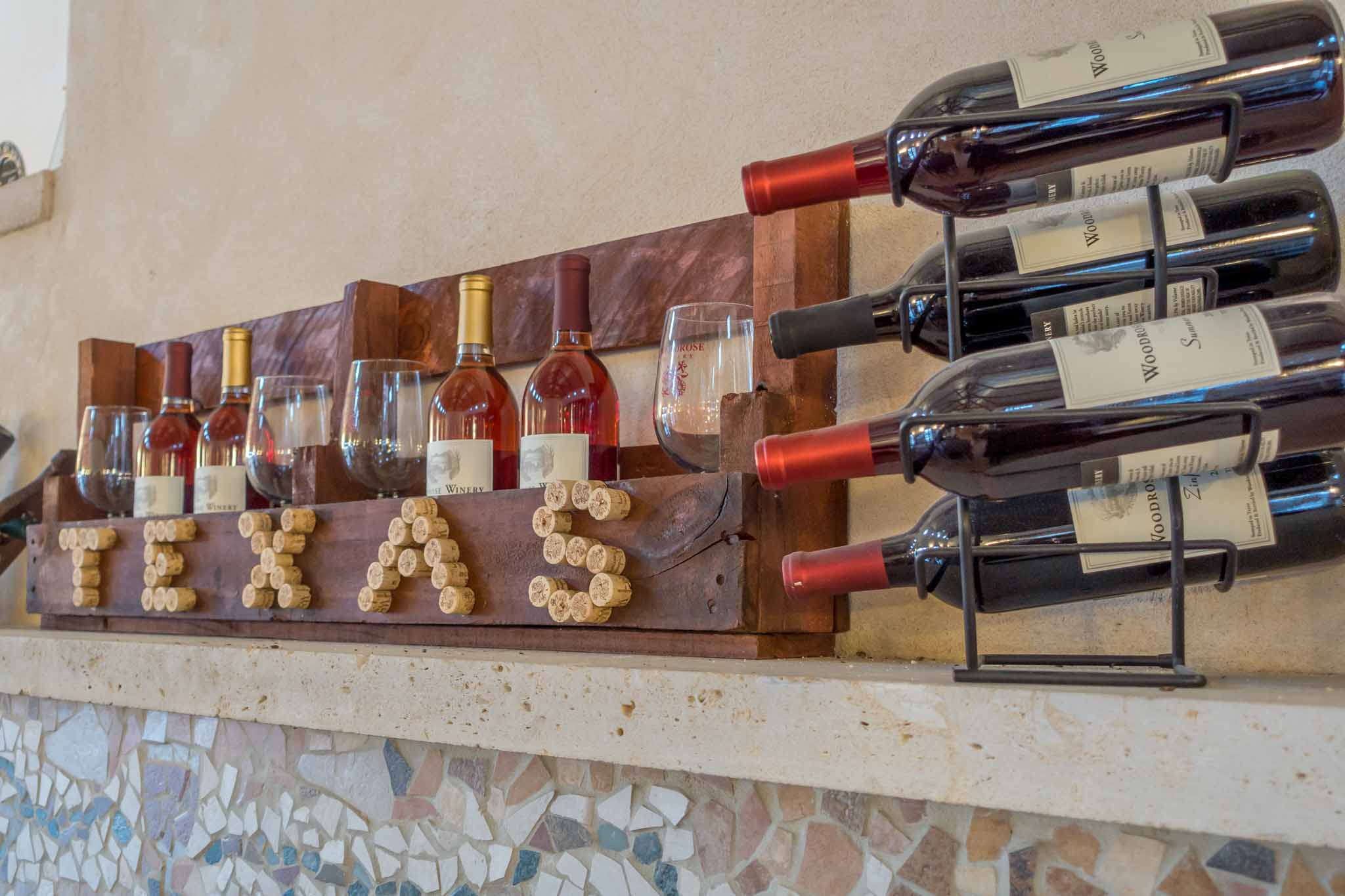 Display of wine bottles, glasses, and corks