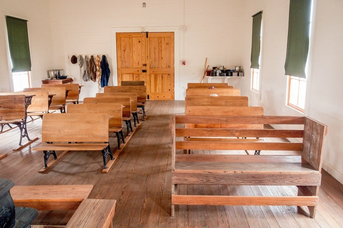 Wooden benches in 1900s schoolhouse. 