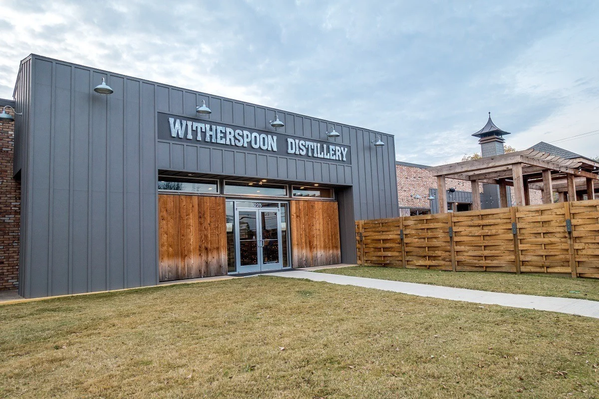 Exterior of gray building with wooden doors