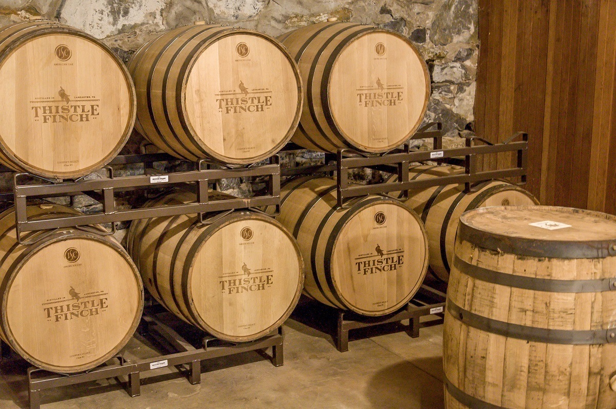 Aging barrels at Thistle Finch Distillery in Lancaster - one of the top Pennsylvania distilleries.