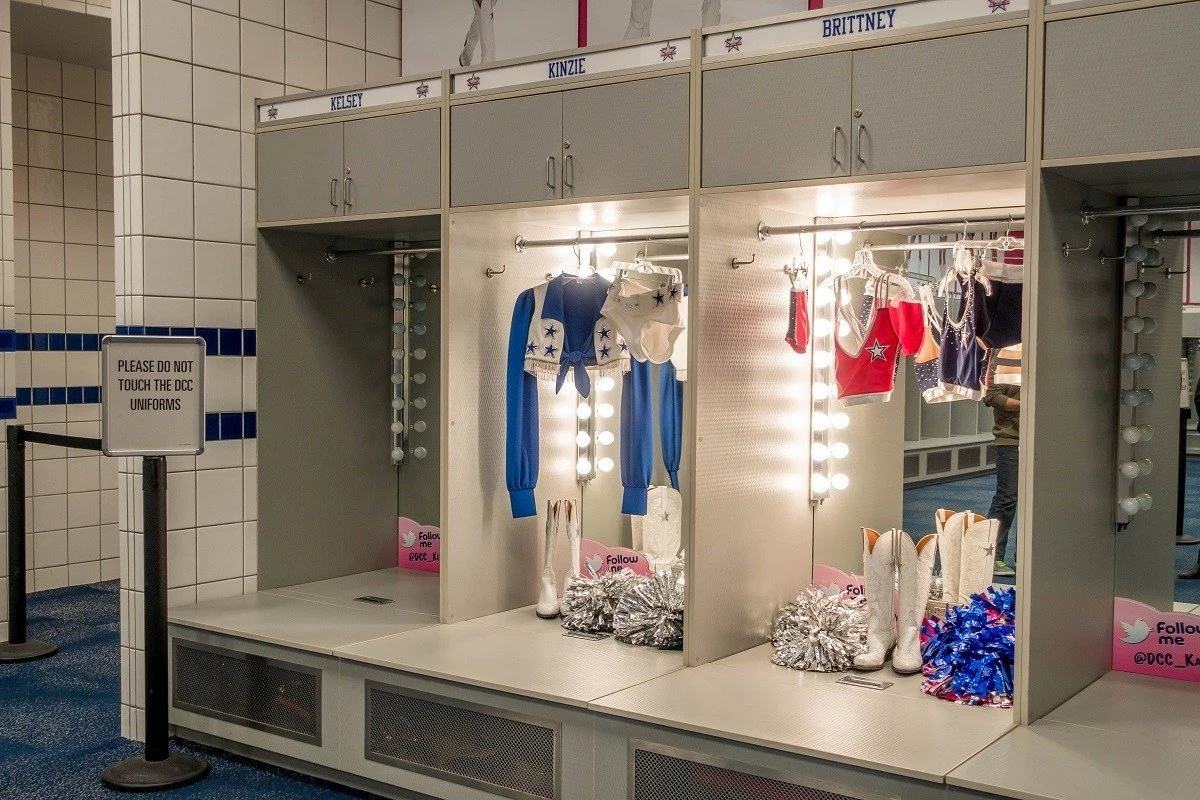 Cheerleaders' uniforms displayed in locker room on a stadium tour