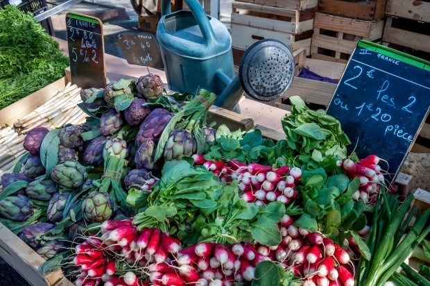 Radishes and artichokes at a Provence market in Arles France